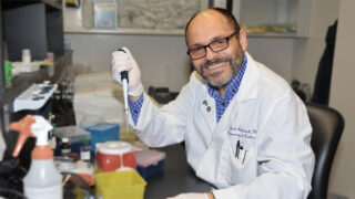 Dr. Ariel Jaitovich posing with a sampling syringe in a lab. Albany Med awarded grant to study COPD
