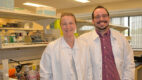 Basic science researchers Sophie Belin, PhD and Yannick Poitelon, PhD, who study Charcot-Marie-Tooth disease (CMT), stand in a lab wearing white coats