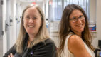 Dr. Cara Grimes and Dr. Kristen Zuloaga stand back-to-back
