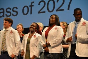 First-year medical students lined up on stage at the White Coat ceremony