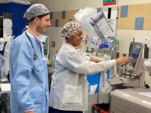 Certified Registered Nurse Anesthetists in operating room using equipment