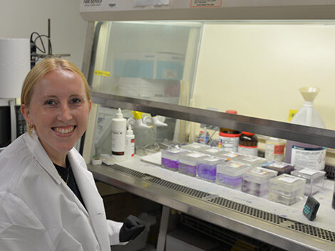 scientist with numerous vials