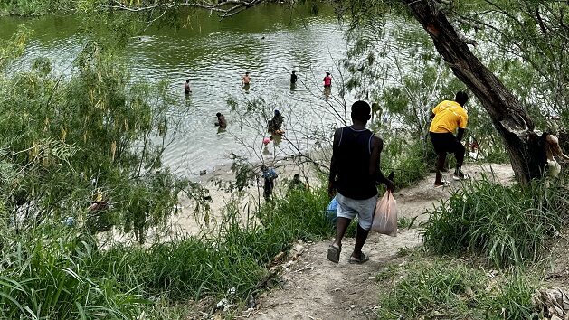 A group of migrants in a river