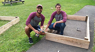 Two Albany Medical College residents building a garden planter box