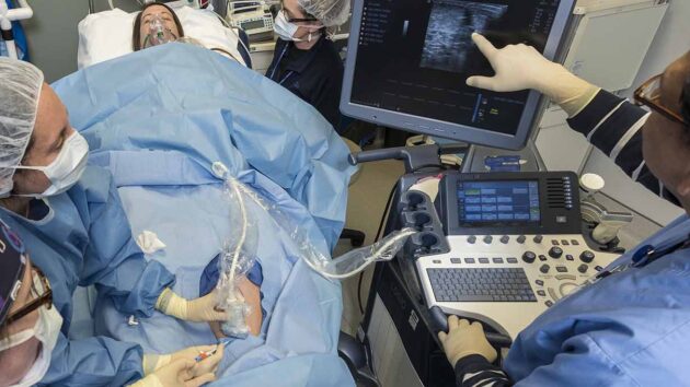 Vascular surgeons and residents perform a procedure