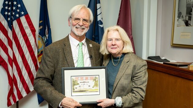 Dr. Andrew Burgess and Alumni President Dr. Ursula Matulonis posing together holding an award