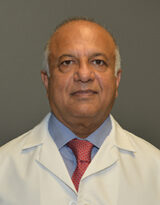 Portrait of Dr. Mushabbar A. Syed in a white coat