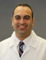 Head shot photo of Dr. Micheal Tadros wearing a white coat