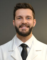 Headshot photo of urologist Dr. Michael Pignanelli wearing a white coat