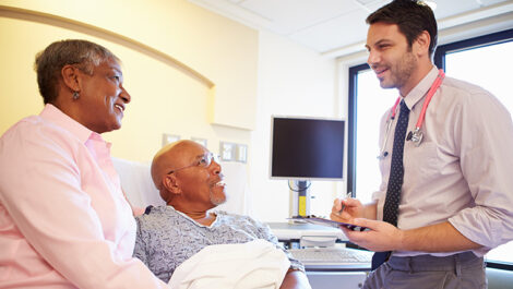 Doctor speaking to a patient and his wife